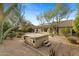 Backyard featuring a hot tub with surrounding desert landscaping and mature trees at 4441 E Via Dona Rd, Cave Creek, AZ 85331