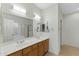 Bright bathroom featuring dual sinks, tile floors, and an oversized mirror at 4441 E Via Dona Rd, Cave Creek, AZ 85331