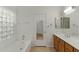 Bright bathroom featuring a soaking tub, tile floors, and a mirrored closet door at 4441 E Via Dona Rd, Cave Creek, AZ 85331