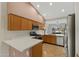 View of a well-lit kitchen with wooden cabinets and stainless steel appliances at 4441 E Via Dona Rd, Cave Creek, AZ 85331