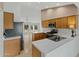 View of the kitchen showcasing countertops, stainless steel appliances, and wood cabinetry at 4441 E Via Dona Rd, Cave Creek, AZ 85331