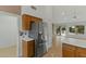 Modern stainless steel refrigerator, tiled floors, and view into the open-concept living area at 4441 E Via Dona Rd, Cave Creek, AZ 85331