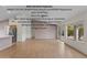 Bright open-plan living room with light wood floors, stainless steel appliances and large windows to the backyard at 4441 E Via Dona Rd, Cave Creek, AZ 85331