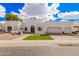 Stunning white home featuring a unique facade, arched entry, manicured desert landscaping and a two-car garage at 5345 E Mclellan Rd # 107, Mesa, AZ 85205