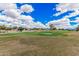 Picturesque golf course view with vibrant green fairways under a bright, partly cloudy sky at 5345 E Mclellan Rd # 107, Mesa, AZ 85205