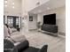 Bright living room boasts wood-look flooring and a contemporary entertainment center at 5345 E Mclellan Rd # 107, Mesa, AZ 85205