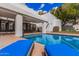 Backyard pool view with two blue lounge chairs in the patio area at 5345 E Mclellan Rd # 107, Mesa, AZ 85205