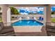 Relaxing covered outdoor seating area overlooks the stunning pool in this backyard oasis at 5345 E Mclellan Rd # 107, Mesa, AZ 85205