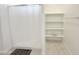 Bright bathroom featuring a tiled floor, shelving, and shower with white curtain at 5463 E Azara Dr, San Tan Valley, AZ 85140