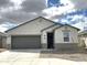 Charming single-story home with a gray garage door, neutral stucco, and a well-maintained yard at 5463 E Azara Dr, San Tan Valley, AZ 85140