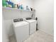 Bright laundry room with a washer, dryer, tile flooring and shelves for storage at 5463 E Azara Dr, San Tan Valley, AZ 85140