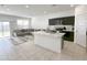 Open-concept living area with kitchen, a comfortable gray sectional, and plenty of space at 5463 E Azara Dr, San Tan Valley, AZ 85140