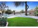 Backyard featuring artificial turf, mountain views, and privacy wall at 6348 W Hill Ln, Glendale, AZ 85310