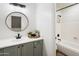 Bathroom featuring grey cabinets, white countertops, and a separate tub with a shower at 6348 W Hill Ln, Glendale, AZ 85310