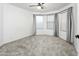 Bedroom featuring carpeted floors, a ceiling fan, and bay windows with natural light at 6348 W Hill Ln, Glendale, AZ 85310