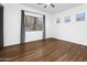 This bedroom features hardwood floors, a ceiling fan, and multiple windows for great natural light at 6348 W Hill Ln, Glendale, AZ 85310