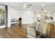 Dining area featuring hardwood floors and an open floorplan with a view of the living room at 6348 W Hill Ln, Glendale, AZ 85310