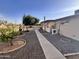 Private backyard featuring low-maintenance landscaping and a concrete walkway at 635 N 67Th Pl, Mesa, AZ 85205