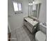 Bright bathroom featuring tile flooring, vanity and a toilet with a closed lid at 635 N 67Th Pl, Mesa, AZ 85205