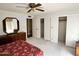 Bedroom features carpet, bed with patterned bedding, dresser and closet at 635 N 67Th Pl, Mesa, AZ 85205