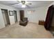 Bedroom with neutral carpet, chair, built-in shelving, and a sliding glass door, creating a peaceful ambiance at 635 N 67Th Pl, Mesa, AZ 85205