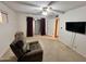 Bedroom with neutral carpet, large chair, closet, and a sliding glass door, a relaxing retreat at 635 N 67Th Pl, Mesa, AZ 85205