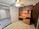 Bedroom featuring paneled walls, tile floors, built-in desk, and a ceiling fan providing a comfortable space at 635 N 67Th Pl, Mesa, AZ 85205