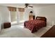 Bedroom featuring carpet, bed with patterned bedding, dresser and window with blinds at 635 N 67Th Pl, Mesa, AZ 85205