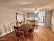 Dining room features wood-style flooring, wooden table with chairs and view into the kitchen at 635 N 67Th Pl, Mesa, AZ 85205