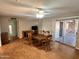 Dining room features wood-style flooring, wooden table with chairs and a ceiling fan at 635 N 67Th Pl, Mesa, AZ 85205