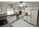 A functional kitchen features white cabinets, stainless steel dishwasher and appliances at 635 N 67Th Pl, Mesa, AZ 85205