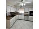 A well-lit kitchen features white cabinets, stainless steel dishwasher and appliances at 635 N 67Th Pl, Mesa, AZ 85205