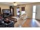 Inviting living room features hardwood flooring, a TV, sofa, and a window at 635 N 67Th Pl, Mesa, AZ 85205