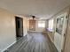 Living room showcasing tile floors, paneled walls, and a brick wall creating a cozy living space at 635 N 67Th Pl, Mesa, AZ 85205