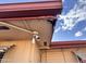 Close-up of damaged wood soffit under the roof line at 635 N 67Th Pl, Mesa, AZ 85205