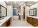 This bathroom is elegantly appointed with dual vanities, a soaking tub, and a walk-in shower at 6576 E Whispering Mesquite Trl, Scottsdale, AZ 85266