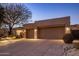 Well-lit exterior view highlighting the modern architecture and low-maintenance desert landscaping at 6576 E Whispering Mesquite Trl, Scottsdale, AZ 85266