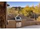 Built-in outdoor grill with stainless steel appliances and beautiful desert landscape views at 6576 E Whispering Mesquite Trl, Scottsdale, AZ 85266