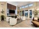 Elegant living room with a built-in bar, sleek wood accents, and bright natural light at 6576 E Whispering Mesquite Trl, Scottsdale, AZ 85266