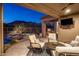 Covered patio featuring a lounge area with mountain views at 6576 E Whispering Mesquite Trl, Scottsdale, AZ 85266