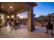 Spacious outdoor patio with comfortable seating, a grill, and stunning mountain views at sunset at 6576 E Whispering Mesquite Trl, Scottsdale, AZ 85266