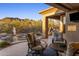 Inviting outdoor patio featuring comfortable seating, desert scenery, and a built-in grill area at 6576 E Whispering Mesquite Trl, Scottsdale, AZ 85266