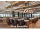 Upscale restaurant with a wrap around bar with modern lighting fixtures and desert views at 6576 E Whispering Mesquite Trl, Scottsdale, AZ 85266