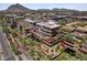 Stunning aerial view of community buildings with rooftop patios, desert landscaping, and mountain views in the background at 7167 E Rancho Vista Dr # 2005, Scottsdale, AZ 85251