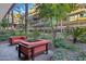 Courtyard with brick flooring, red outdoor seating, and lush landscaping, with a view of the building in the background at 7167 E Rancho Vista Dr # 2005, Scottsdale, AZ 85251