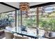 Dining area with a glass table, modern lighting, and scenic views of lush landscaping at 7167 E Rancho Vista Dr # 2005, Scottsdale, AZ 85251