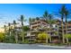 Beautiful multi-story building exterior with balconies, lush landscaping, and palm trees, creating a tropical oasis at 7167 E Rancho Vista Dr # 2005, Scottsdale, AZ 85251