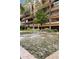 Beautiful water feature with stone base in community courtyard with lush landscaping and multi-story building in the background at 7167 E Rancho Vista Dr # 2005, Scottsdale, AZ 85251