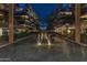 Picturesque nighttime view of the building's water feature, surrounded by tall palm trees and lush landscaping at 7167 E Rancho Vista Dr # 2005, Scottsdale, AZ 85251