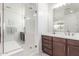 Bright bathroom with a walk in shower and a white vanity at 7540 E Pampa Ave, Mesa, AZ 85212